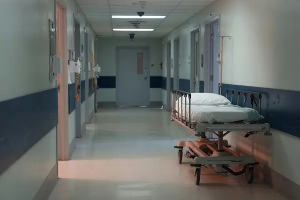 Illustration: an empty hospital corridor.