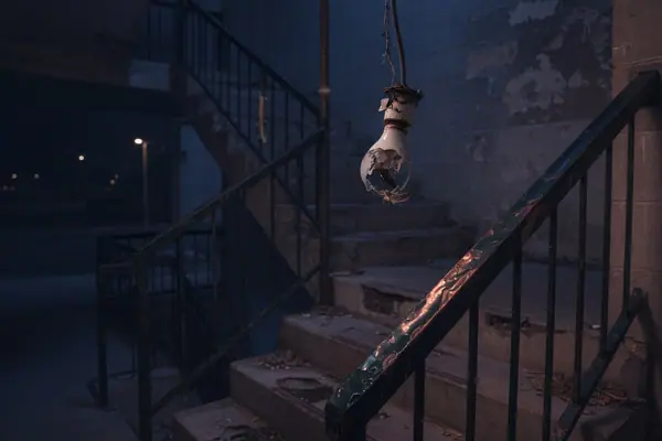 Illustration: a poorly lit apartment stairwell at night.